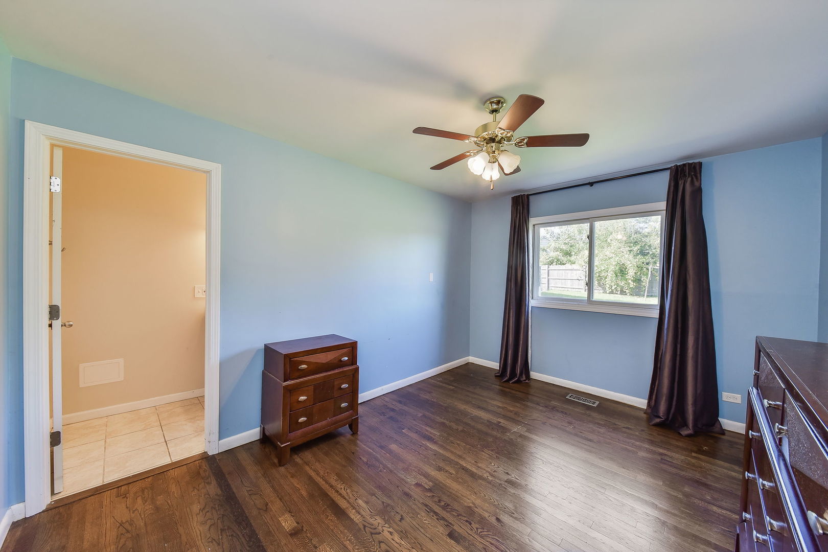850 Ash Road Hoffman Estates, IL 60169 - Photo 10 of 16 a view of an empty room with a window and wooden floor