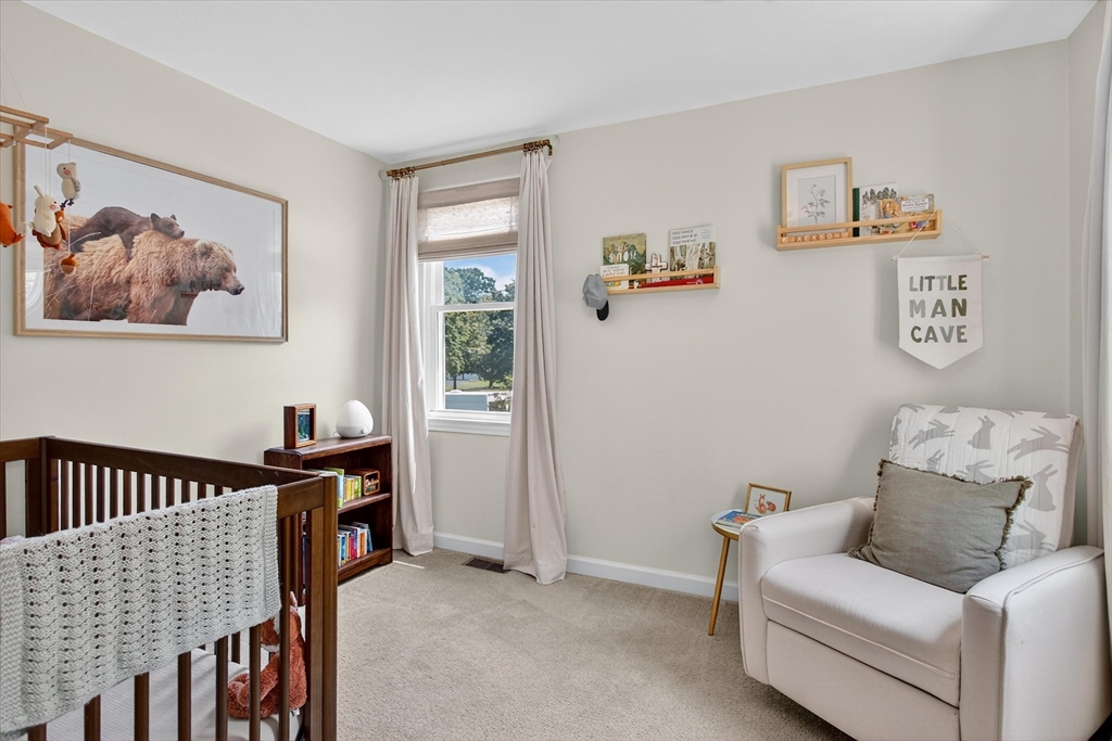34 Timberline Road Millis, MA 02054 - Photo 21 of 42 a living room with furniture and baby crib