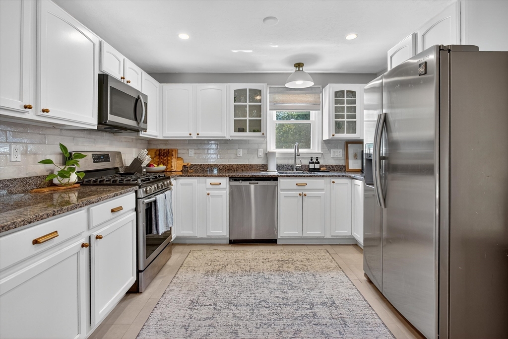 34 Timberline Road Millis, MA 02054 - Photo 10 of 42 a kitchen with stainless steel appliances granite countertop a sink a stove a refrigerator and cabinets