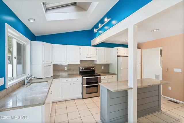 a kitchen with a sink stainless steel appliances and cabinets