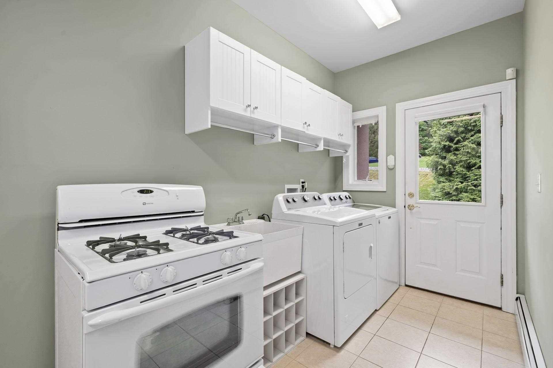 67 Greenwich Avenue Central Valley, NY 10917 - Photo 11 of 30 a kitchen with appliances a stove a sink and white cabinets
