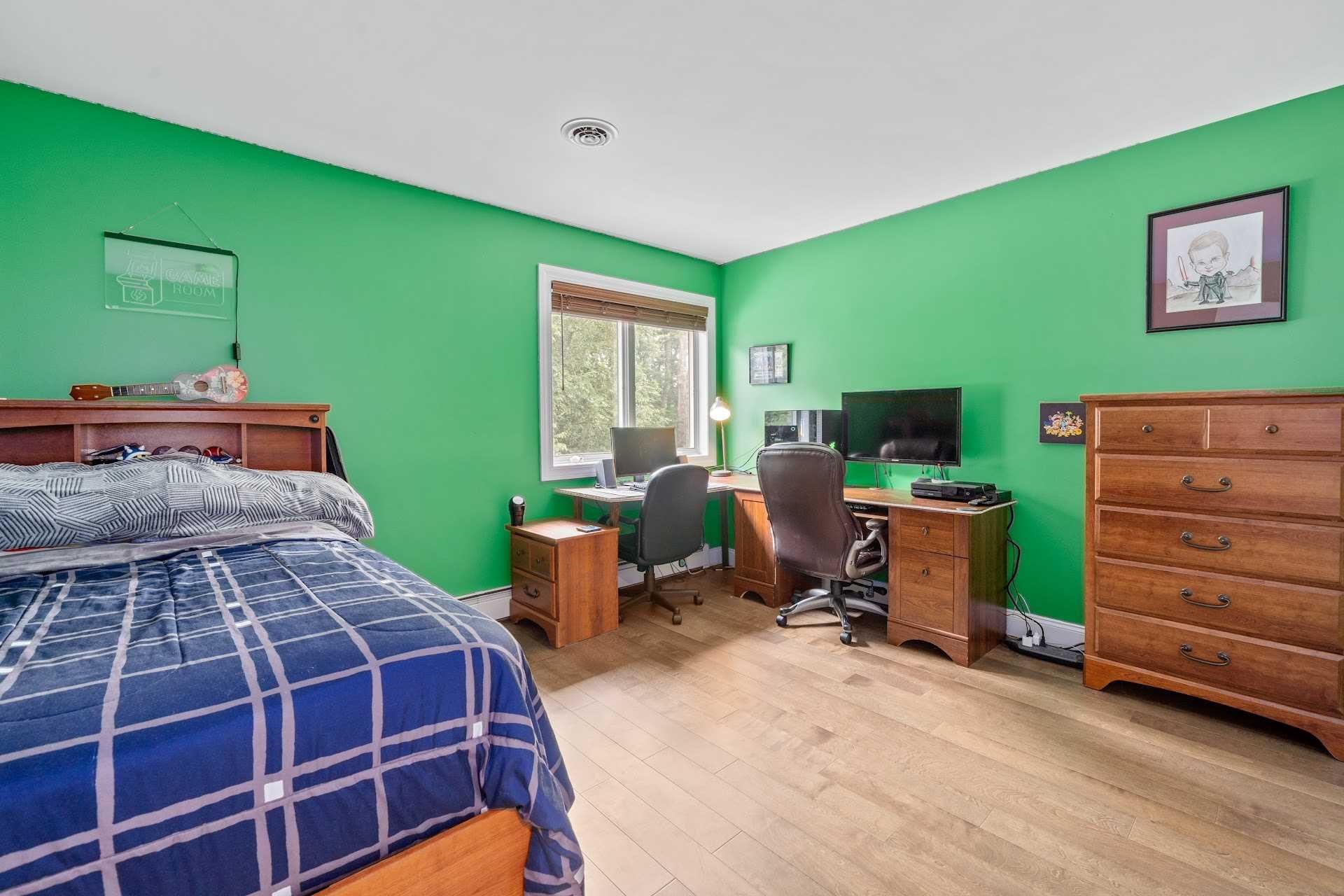 67 Greenwich Avenue Central Valley, NY 10917 - Photo 18 of 30 a bedroom with a bed and a bookshelf