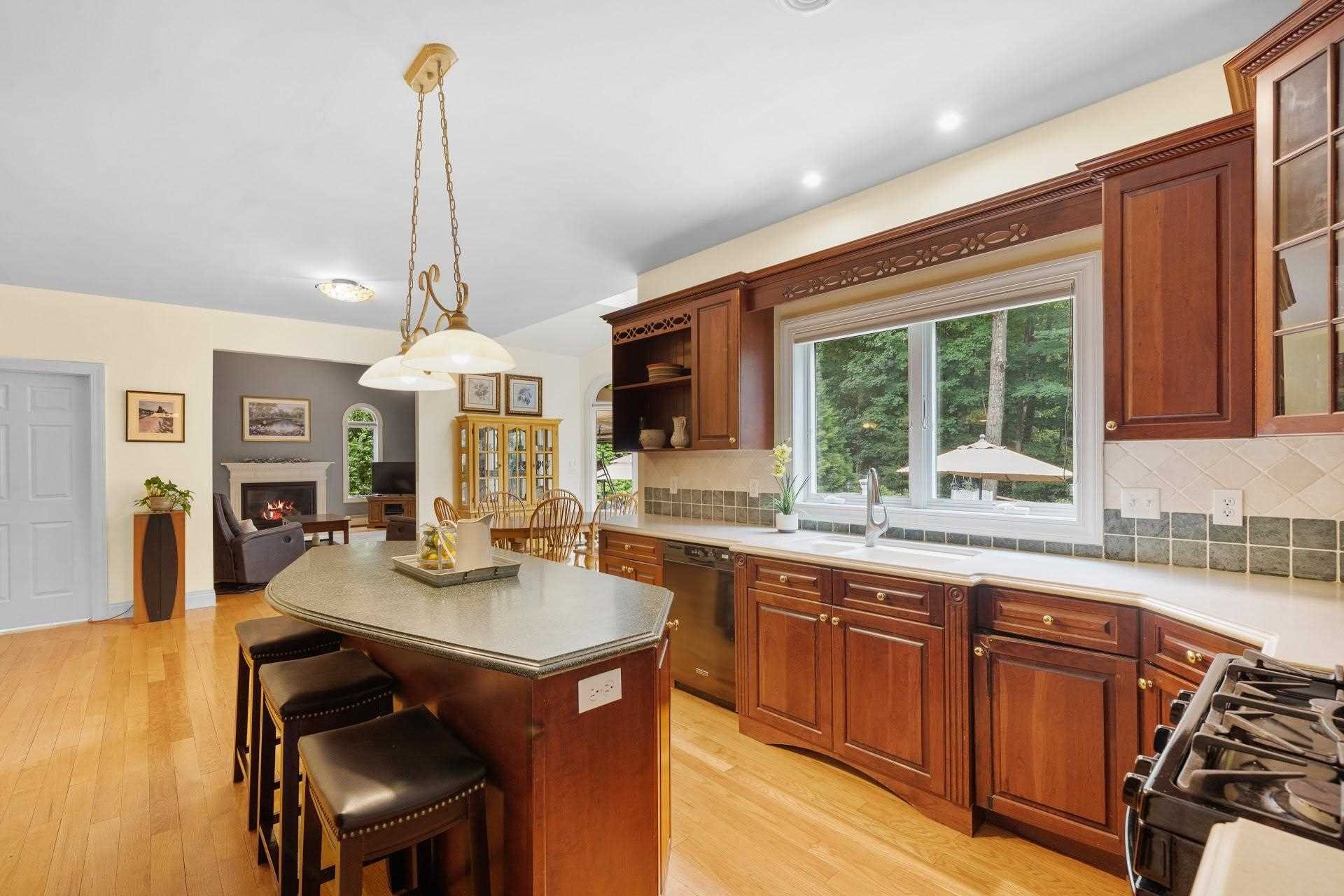 67 Greenwich Avenue Central Valley, NY 10917 - Photo 4 of 30 a kitchen with stainless steel appliances granite countertop wooden cabinets a stove a sink and a wooden floors
