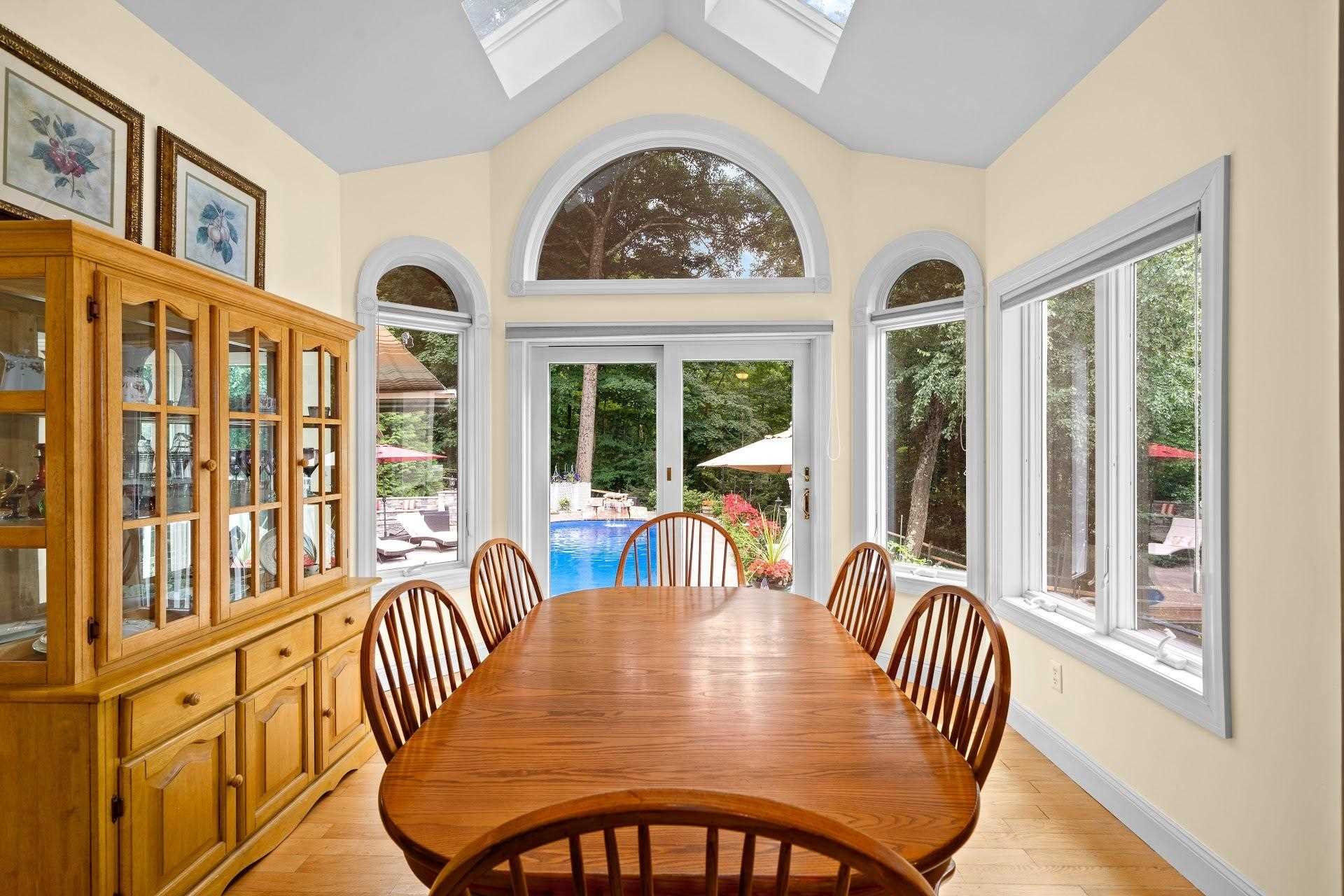 67 Greenwich Avenue Central Valley, NY 10917 - Photo 7 of 30 a view of a dining room with furniture large windows and a chandelier