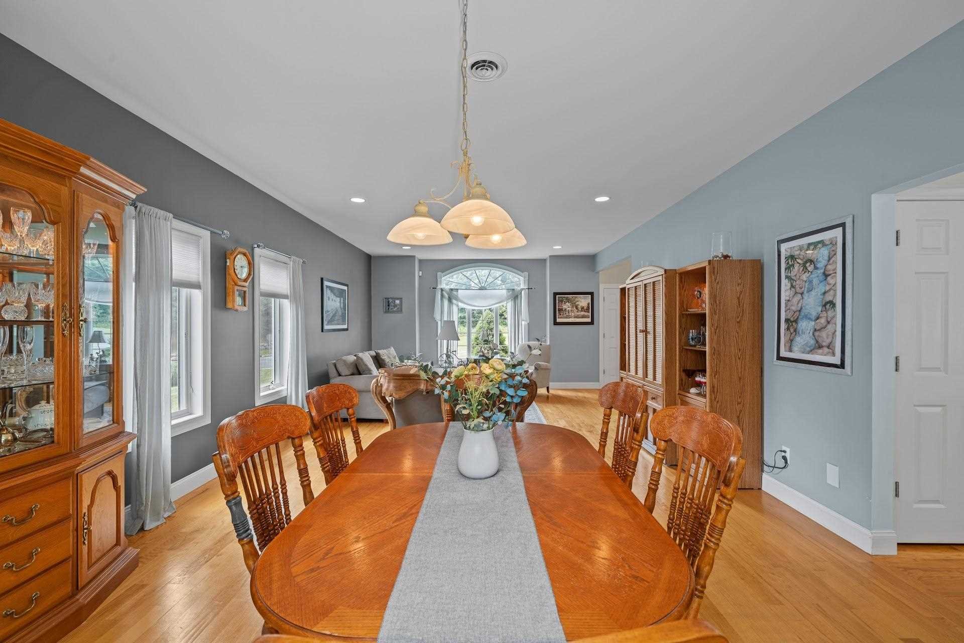 67 Greenwich Avenue Central Valley, NY 10917 - Photo 9 of 30 a dining room with furniture a chandelier and wooden floor