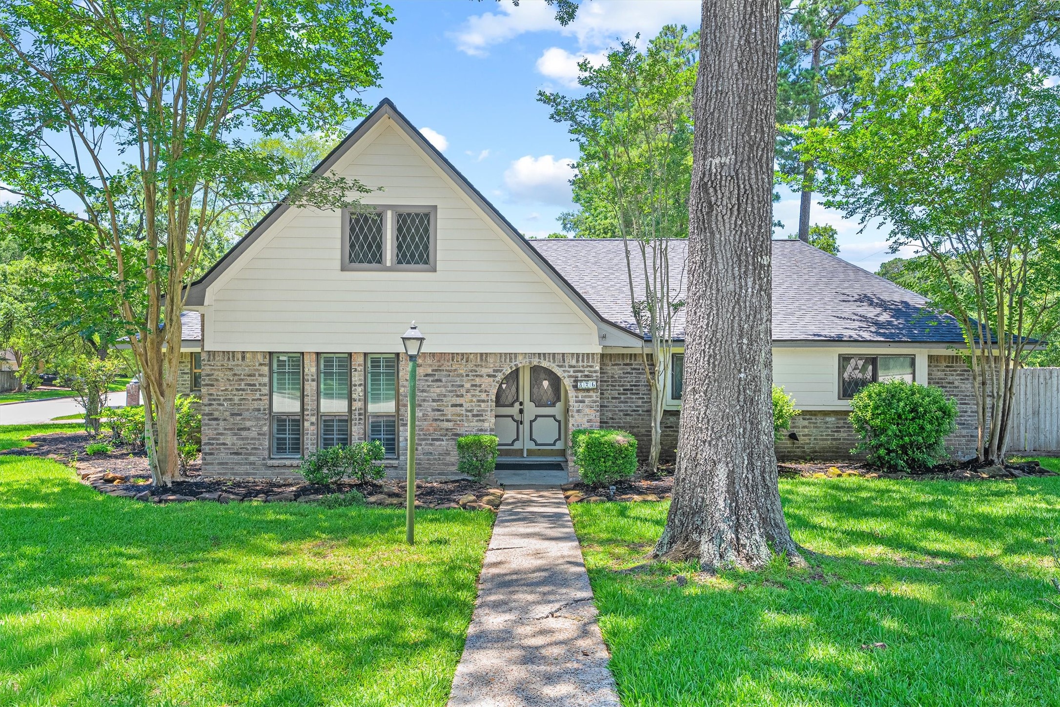 826 North Rivershire Drive Conroe, TX 77304 - Photo 2 of 46 From this angle, the distinctive roofline and arched double-door entry really take center stage — corner lot, brand new roof, under $400k. Do the math.