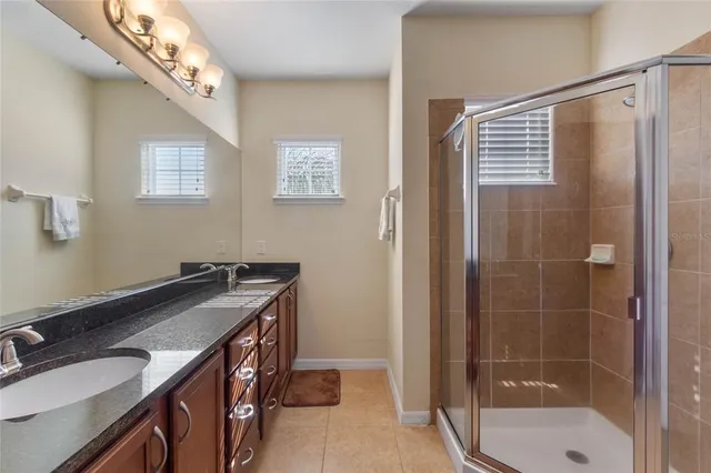 a bathroom with a sink a mirror and a shower