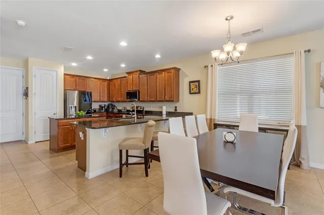 a large kitchen with a table and chairs