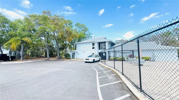 a view of a house with swimming pool next to a yard