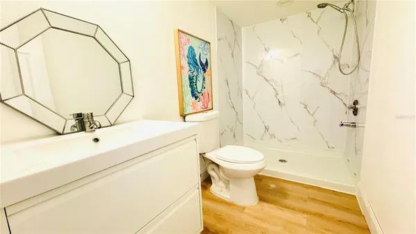 a bathroom with a toilet sink and shower