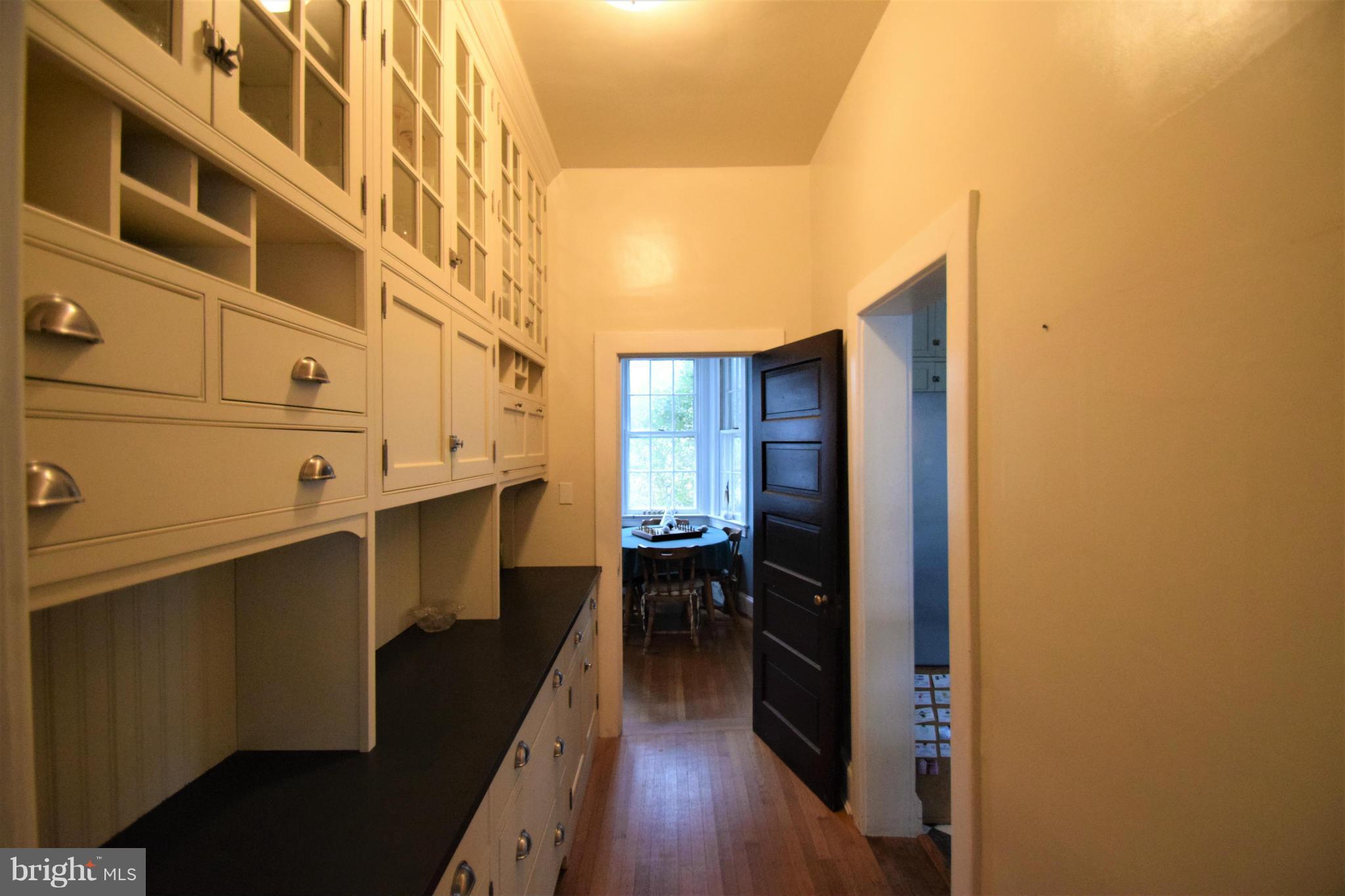 601 Charing Cross Road Baltimore, MD 21229 - Photo 14 of 30 a kitchen with cabinets and wooden floor