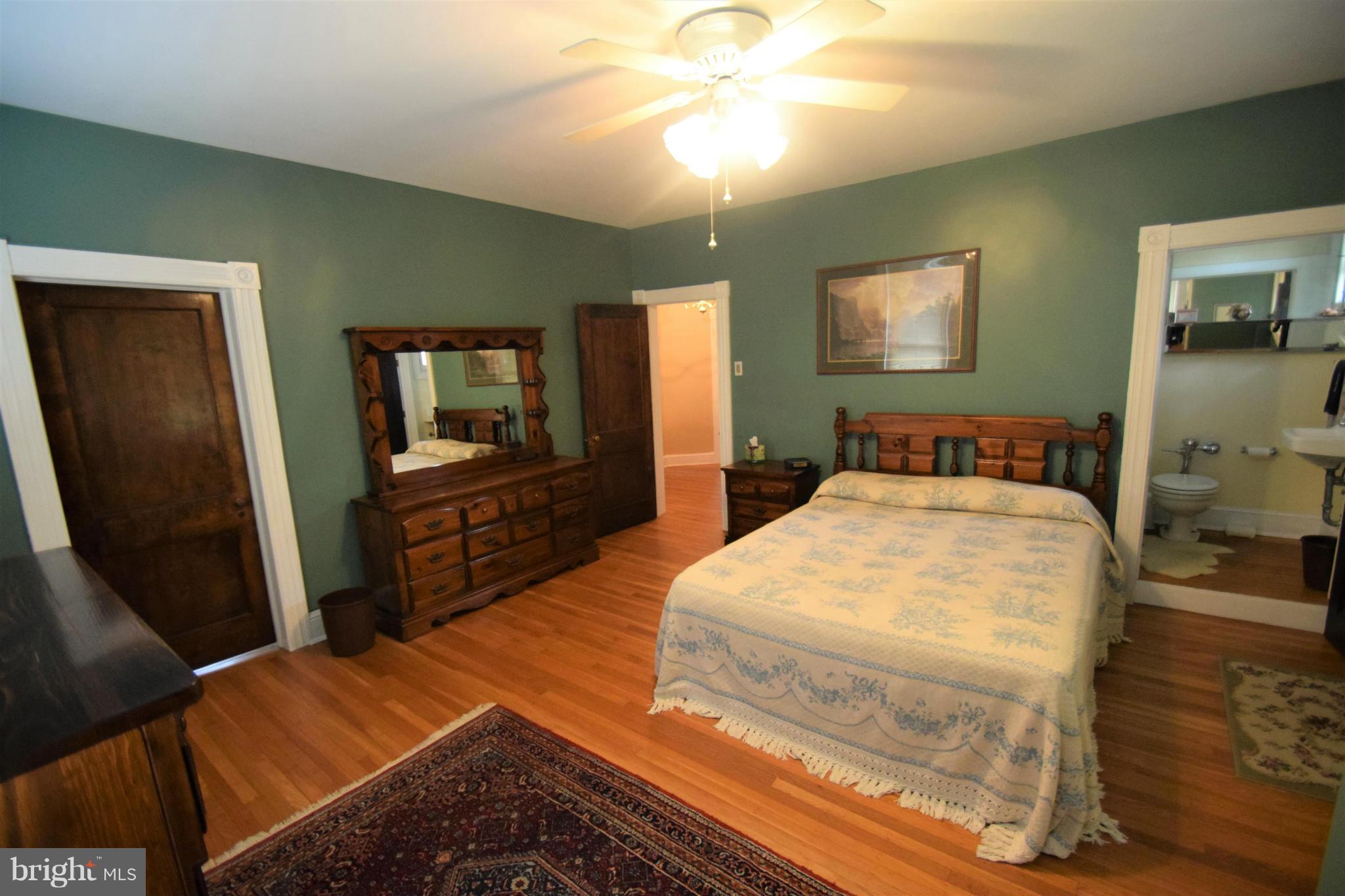 601 Charing Cross Road Baltimore, MD 21229 - Photo 17 of 30 a bedroom with a bed and a flat tv screen on dresser
