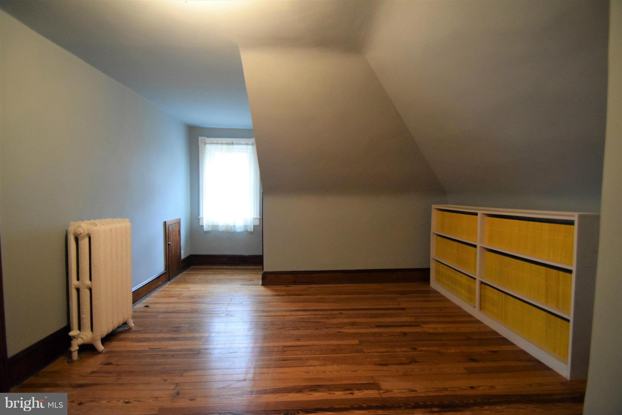601 Charing Cross Road Baltimore, MD 21229 - Photo 21 of 30 an empty room with wooden floor and windows