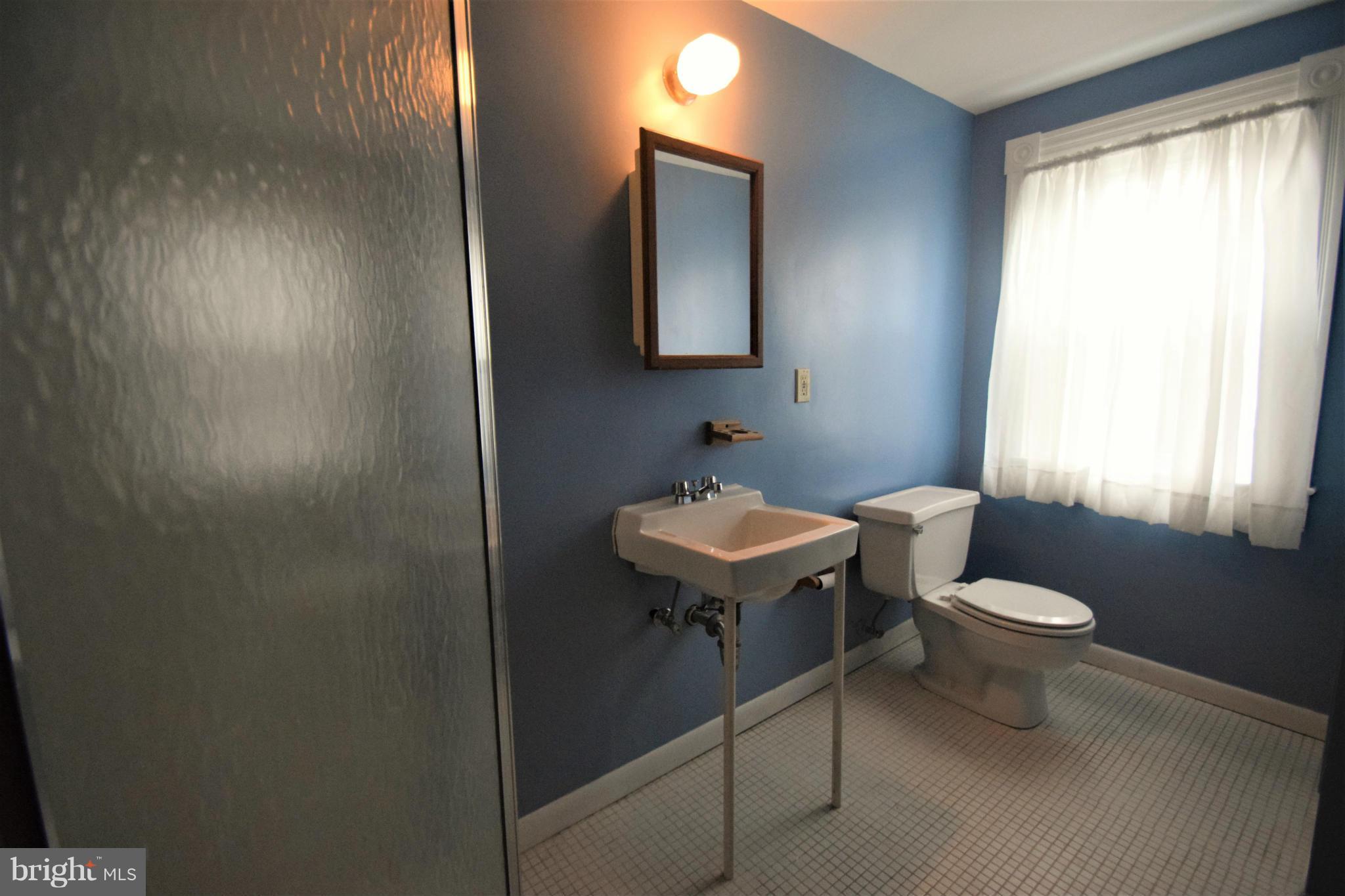 601 Charing Cross Road Baltimore, MD 21229 - Photo 23 of 30 a bathroom with a sink a toilet and mirror