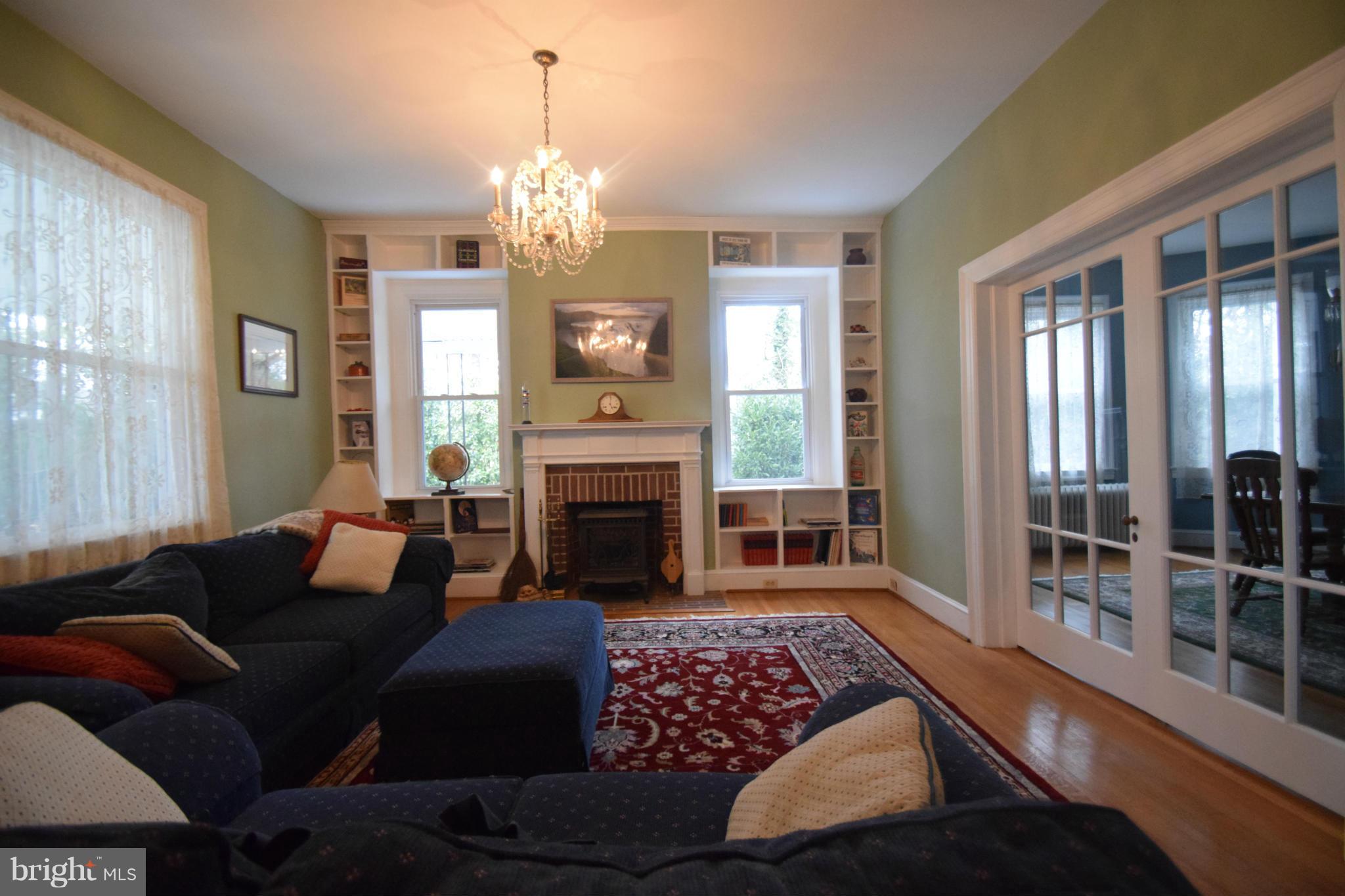 601 Charing Cross Road Baltimore, MD 21229 - Photo 4 of 30 a living room with furniture a chandelier and a fireplace