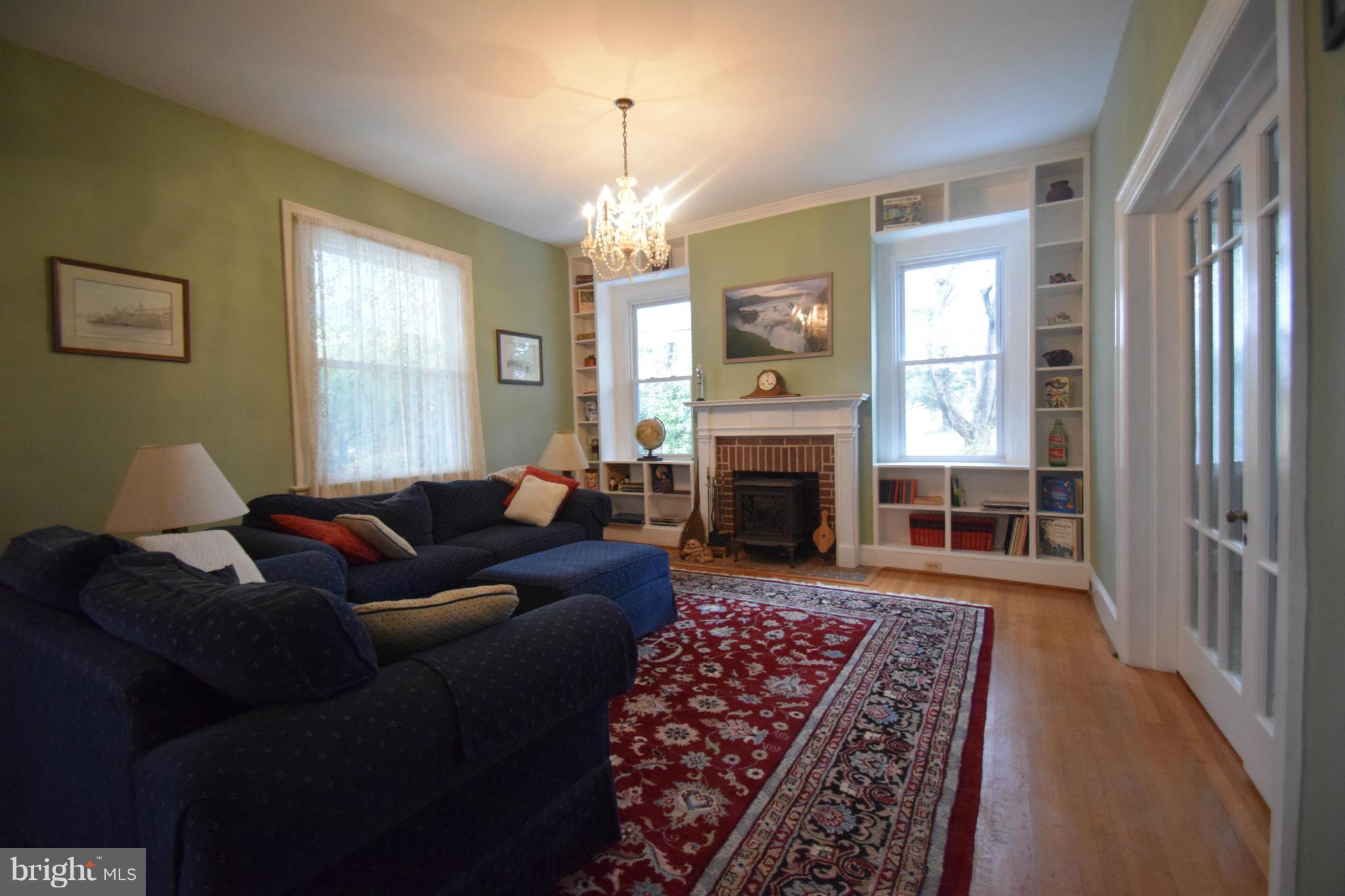 601 Charing Cross Road Baltimore, MD 21229 - Photo 5 of 30 a living room with furniture a fireplace and a chandelier
