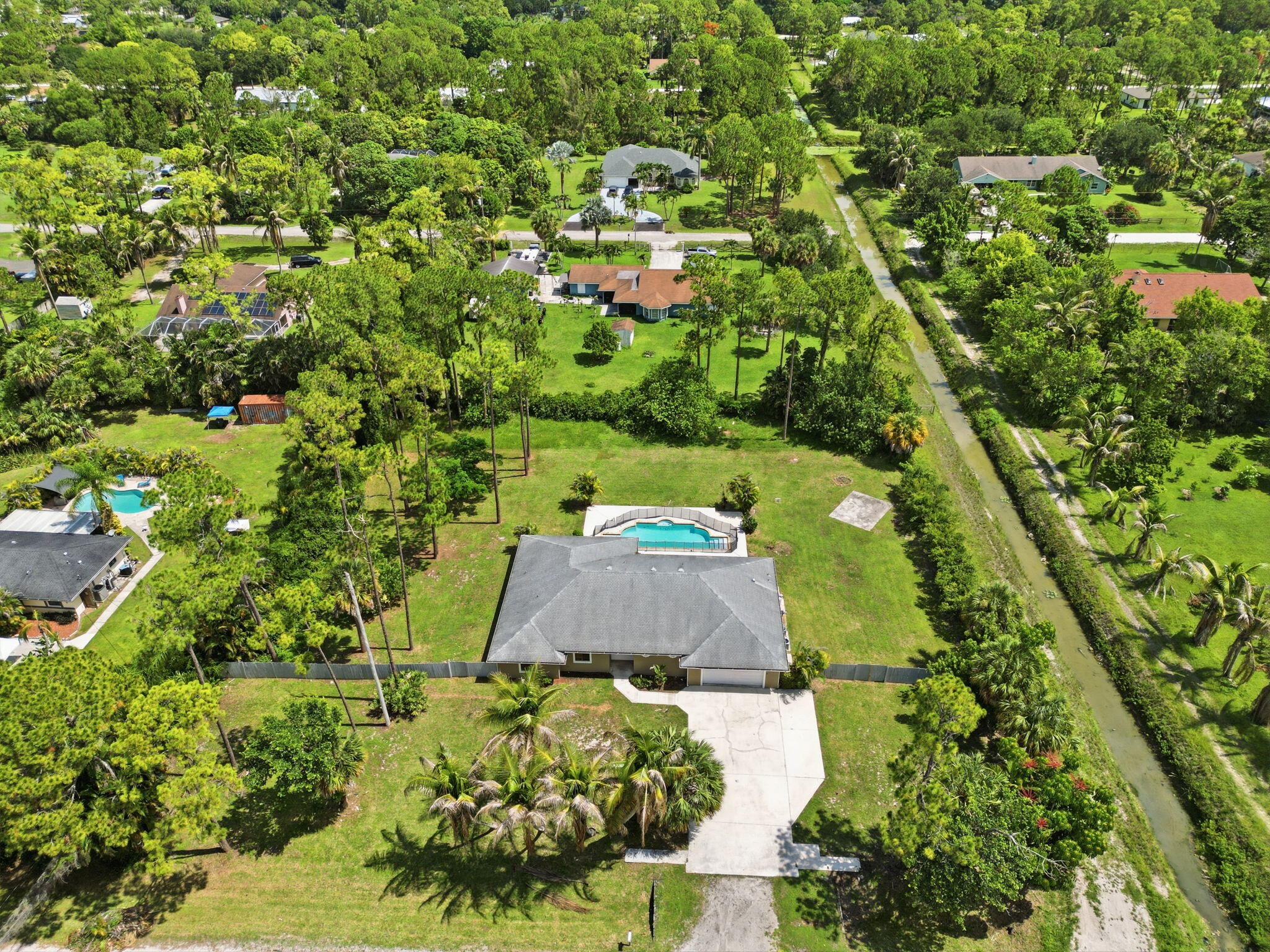 15731 85th Road North Loxahatchee, FL 33470 - Photo 53 of 65 an aerial view of a residential houses with yard