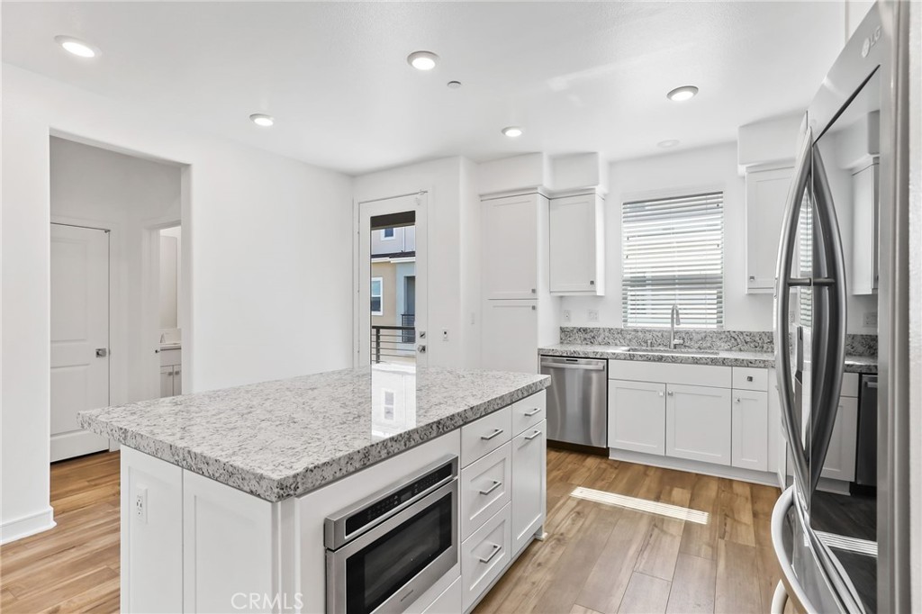 454 Palermo Lake Forest, CA 92630 - Photo 11 of 44 a kitchen with granite countertop a sink stove and refrigerator