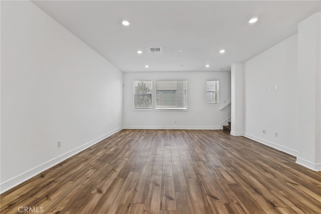 454 Palermo Lake Forest, CA 92630 - Photo 15 of 44 an empty room with wooden floor and windows