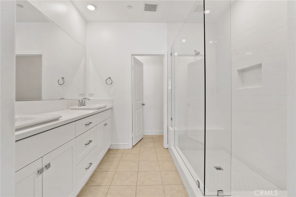 454 Palermo Lake Forest, CA 92630 - Photo 20 of 44 a bathroom with a granite countertop sink two mirror and a bathtub