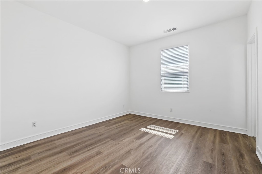 454 Palermo Lake Forest, CA 92630 - Photo 23 of 44 a view of empty room with wooden floor and fan