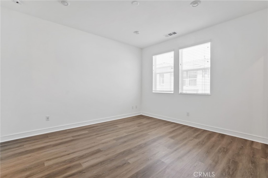 454 Palermo Lake Forest, CA 92630 - Photo 25 of 44 an empty room with wooden floor and windows