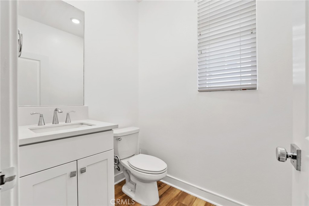 454 Palermo Lake Forest, CA 92630 - Photo 26 of 44 a bathroom with a toilet sink vanity and mirror