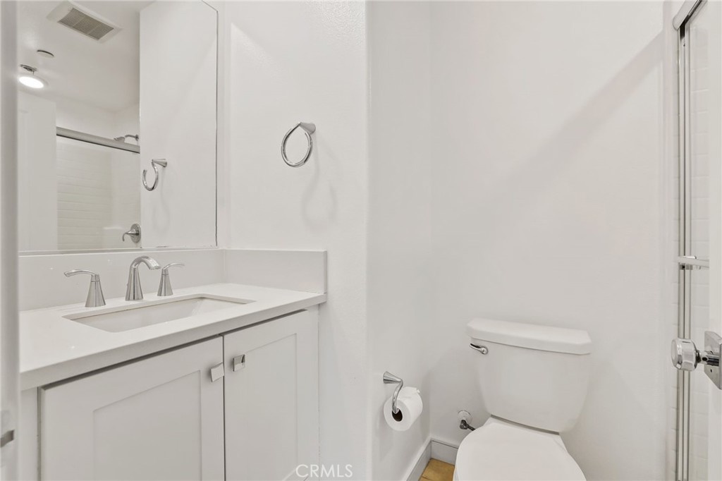 454 Palermo Lake Forest, CA 92630 - Photo 28 of 44 a bathroom with a toilet sink vanity and mirror