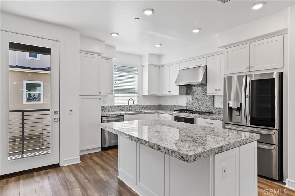 454 Palermo Lake Forest, CA 92630 - Photo 5 of 44 a kitchen with stainless steel appliances granite countertop a sink stove and refrigerator