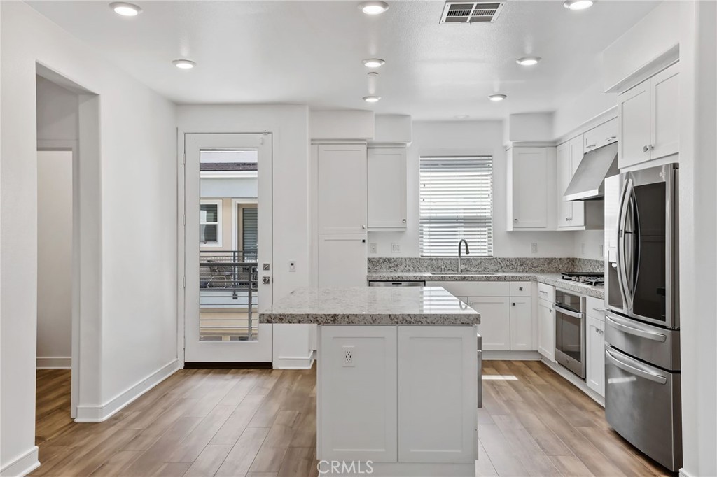 454 Palermo Lake Forest, CA 92630 - Photo 6 of 44 a kitchen with stainless steel appliances granite countertop a refrigerator and a stove top oven