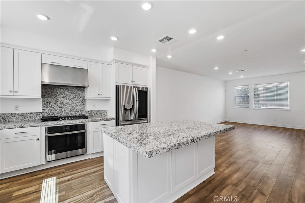 454 Palermo Lake Forest, CA 92630 - Photo 8 of 44 a kitchen with stainless steel appliances granite countertop a stove a sink and a refrigerator