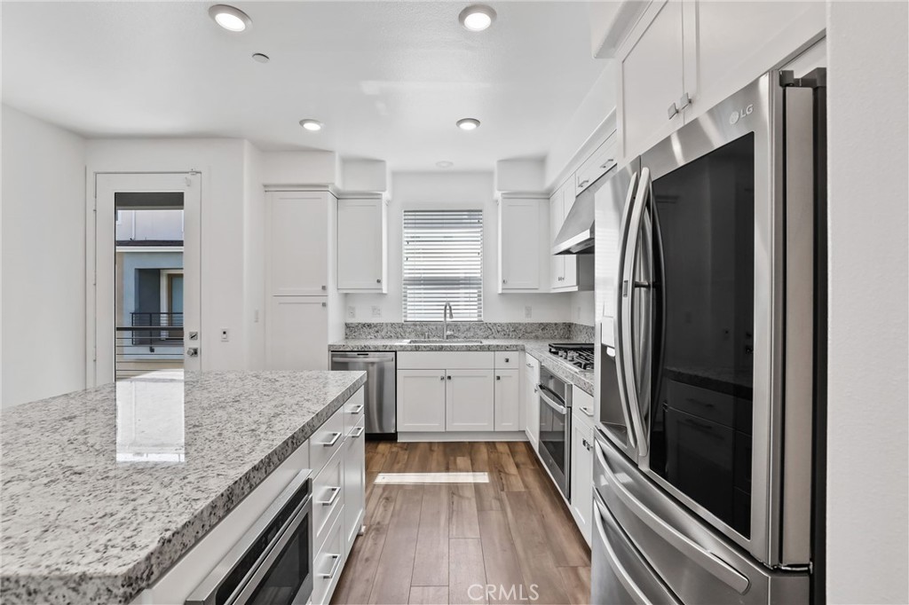 454 Palermo Lake Forest, CA 92630 - Photo 10 of 44 a kitchen with a refrigerator and a sink