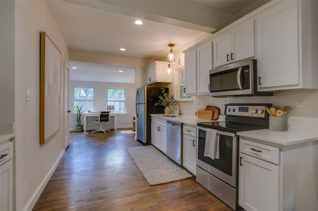 2606 West 12th Street Dallas, TX 75211 - Photo 18 of 36 a kitchen with cabinets and wooden floor
