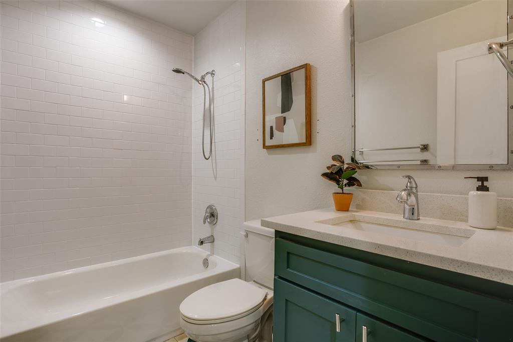 2606 West 12th Street Dallas, TX 75211 - Photo 28 of 36 a bathroom with a sink a toilet and shower
