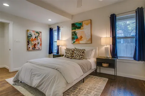 a bedroom with a bed and a painting on the wall