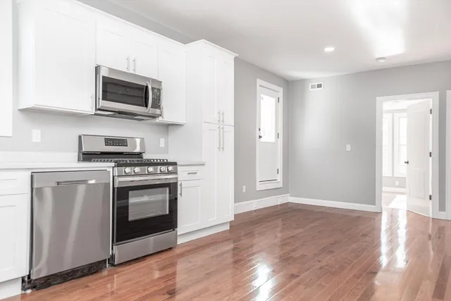 a kitchen with stainless steel appliances a stove a microwave and cabinets
