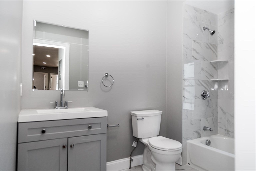 16 Gaston Street, Unit 2F Boston, MA 02121 - Photo 6 of 7 a bathroom with a sink toilet vanity and tub