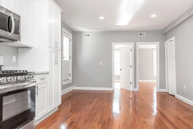 a view of a kitchen with a stove cabinets and wooden floor