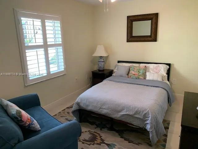a bedroom with bed and a window