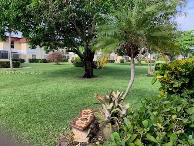 a green field with lots of trees