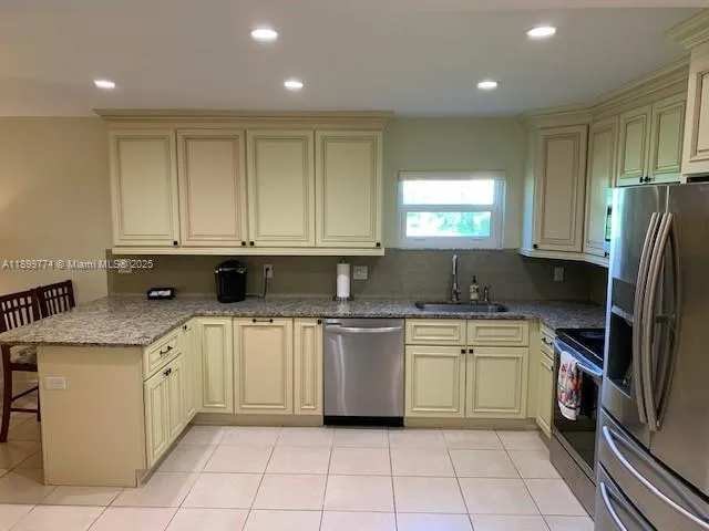 a kitchen with a sink window and cabinets