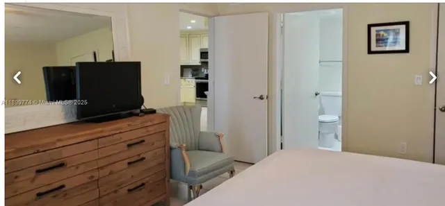 a bedroom with a bed and a television