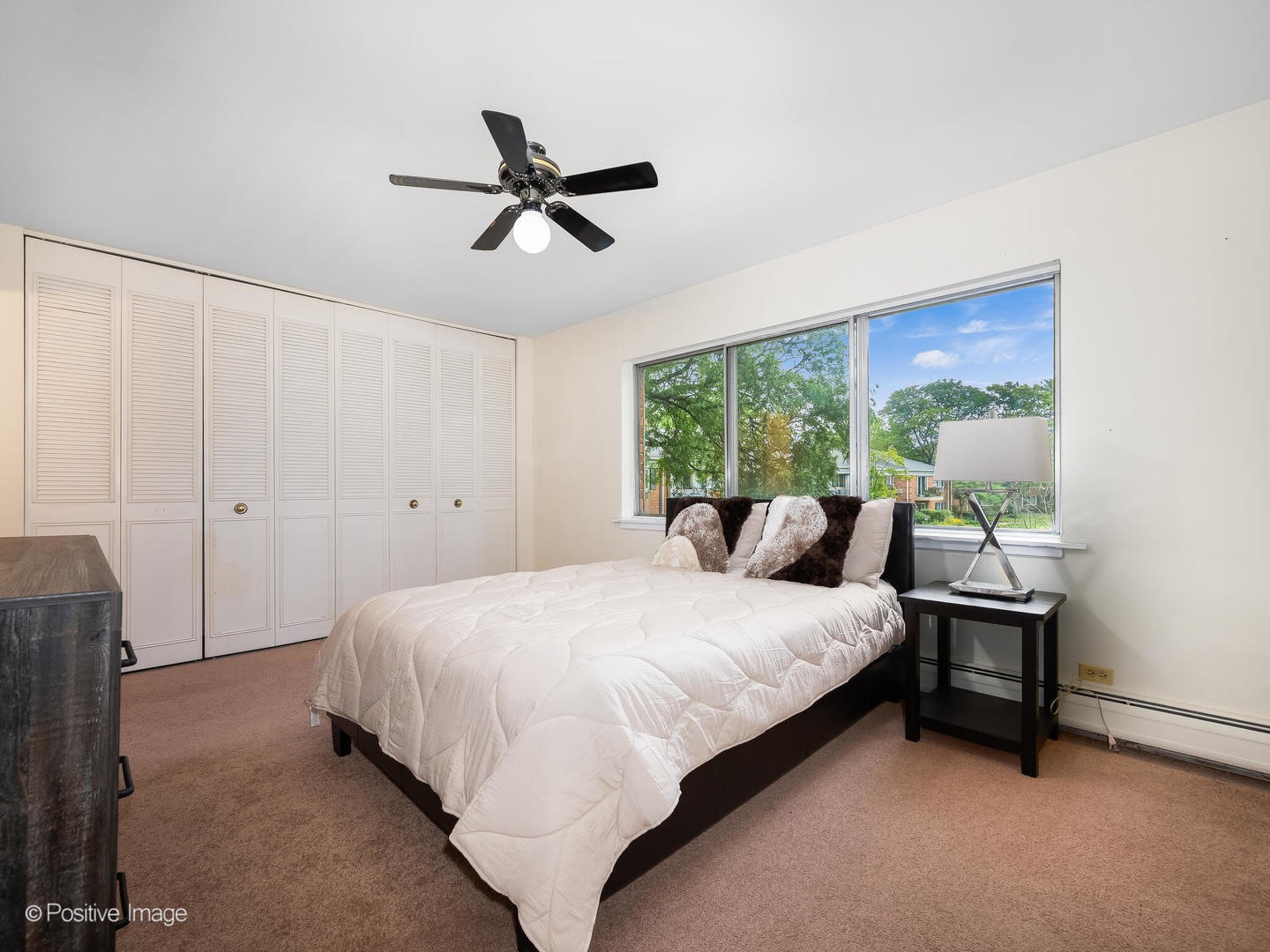 2407 South Goebbert Road, Unit G202 Arlington Heights, IL 60005 - Photo 12 of 17 a bedroom with a bed and a window