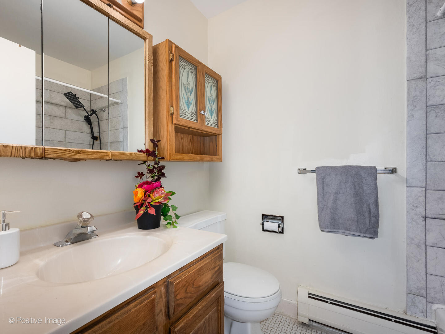 2407 South Goebbert Road, Unit G202 Arlington Heights, IL 60005 - Photo 13 of 17 a bathroom with a sink a toilet and mirror