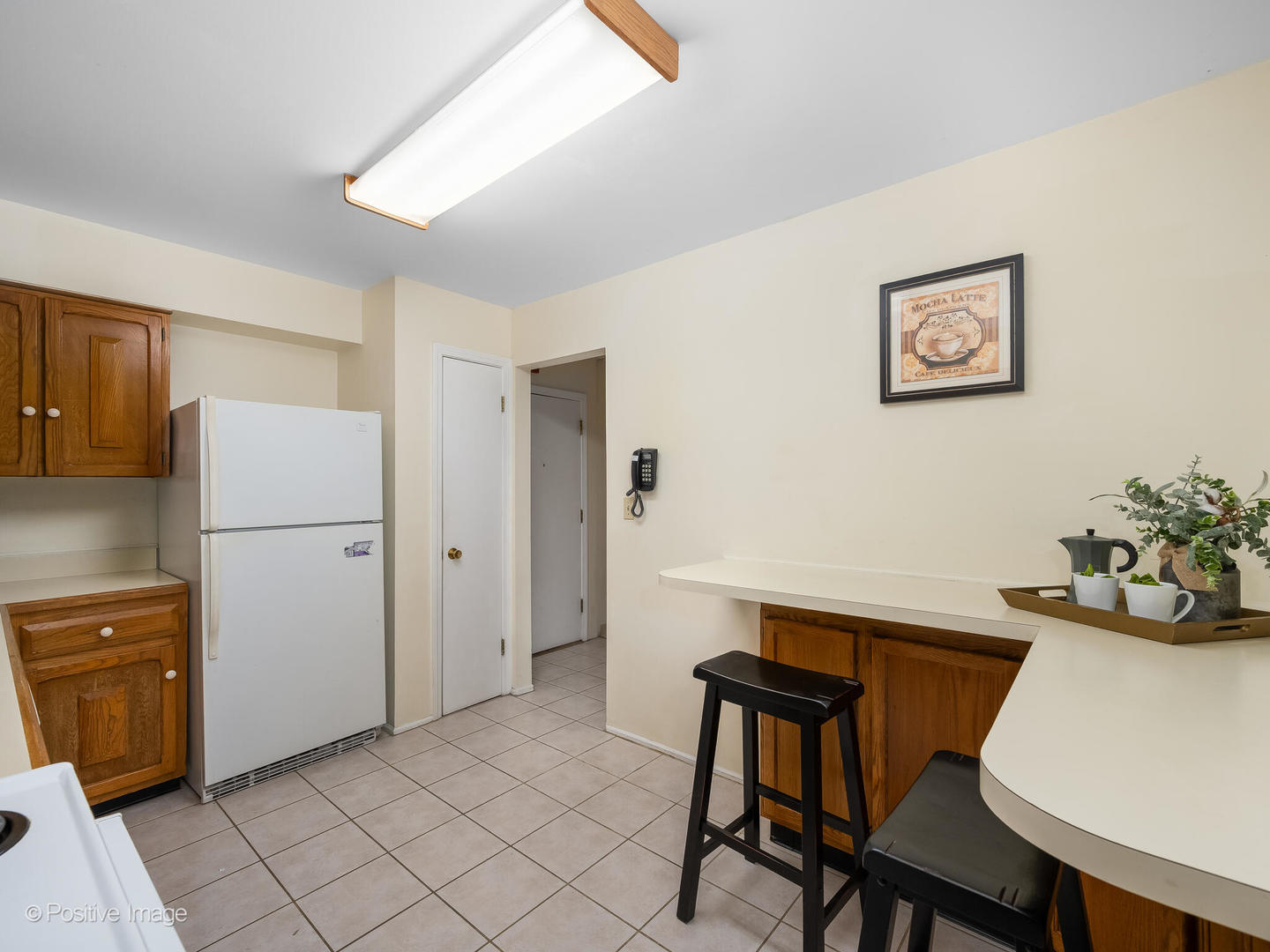 2407 South Goebbert Road, Unit G202 Arlington Heights, IL 60005 - Photo 3 of 17 a workspace room with furniture and wooden floor