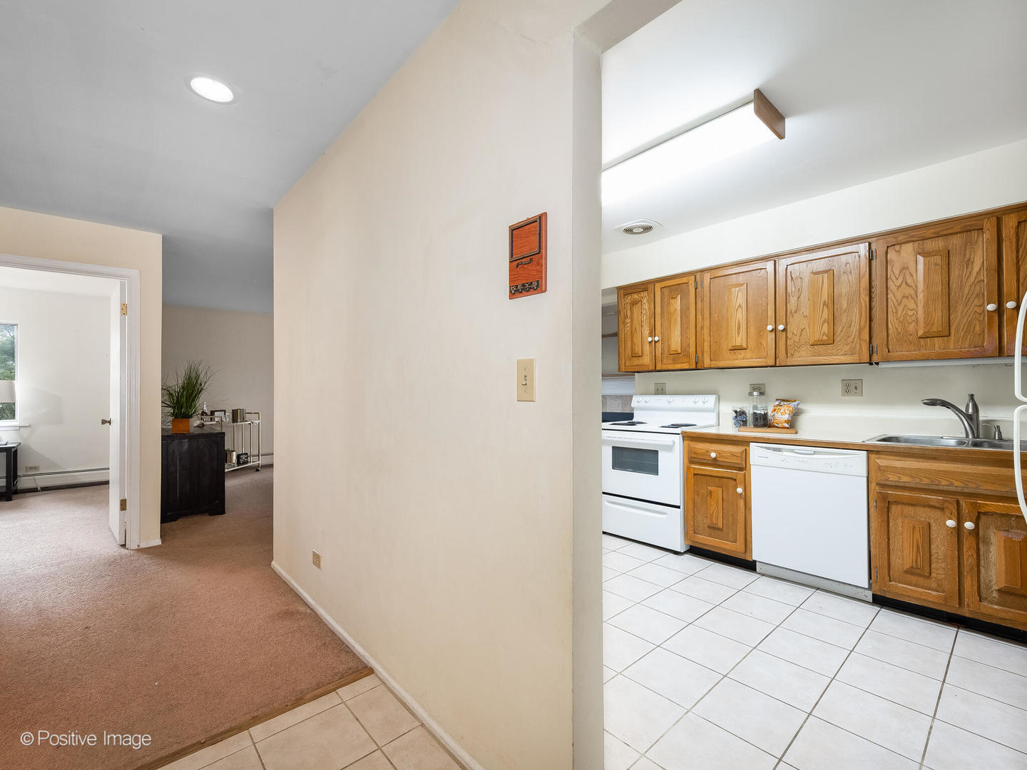 2407 South Goebbert Road, Unit G202 Arlington Heights, IL 60005 - Photo 4 of 17 a kitchen with granite countertop a refrigerator and a stove top oven