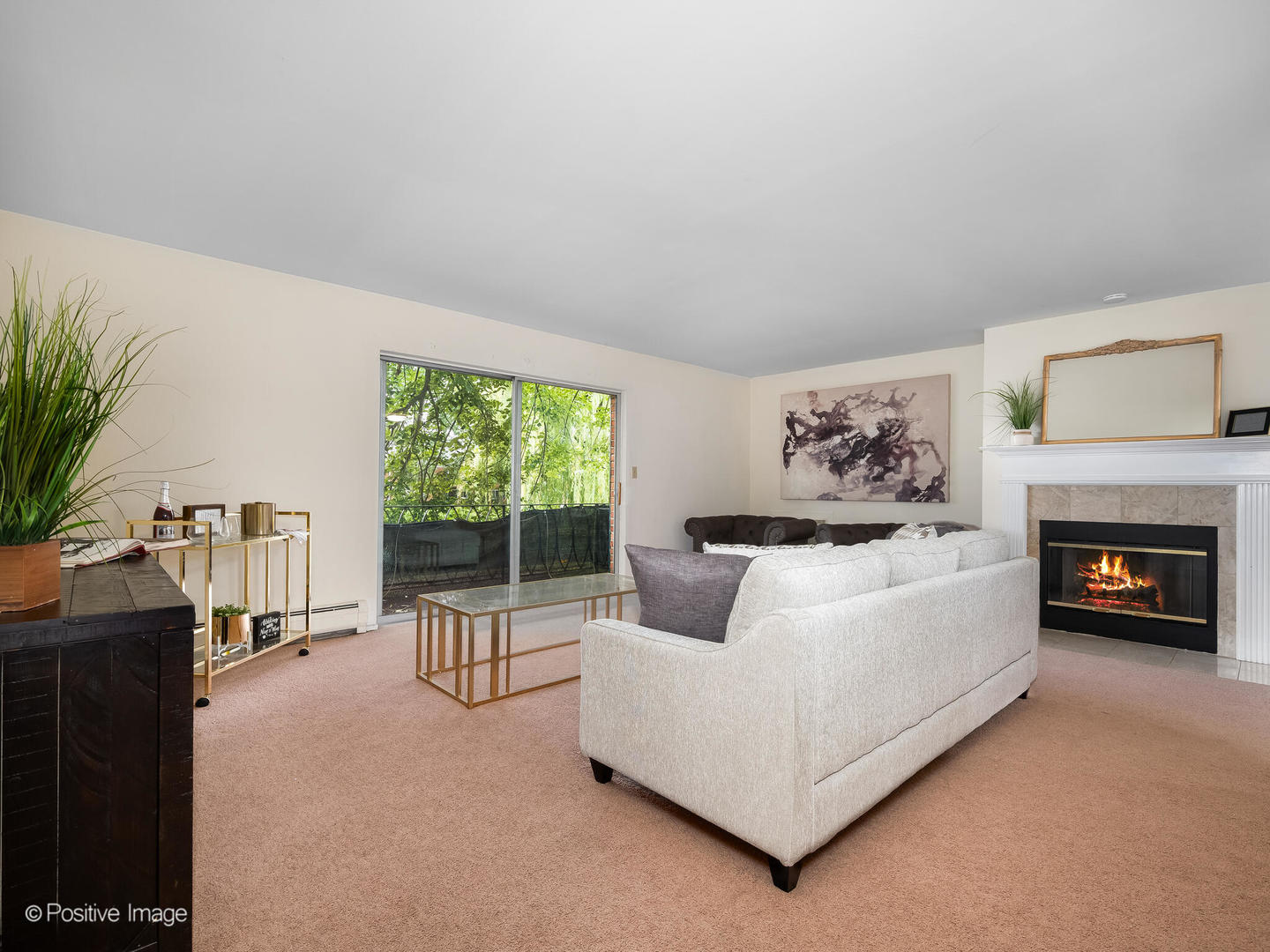 2407 South Goebbert Road, Unit G202 Arlington Heights, IL 60005 - Photo 7 of 17 a living room with furniture and a fireplace