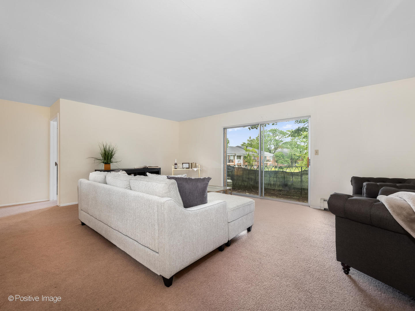 2407 South Goebbert Road, Unit G202 Arlington Heights, IL 60005 - Photo 9 of 17 a living room with furniture and a flat screen tv