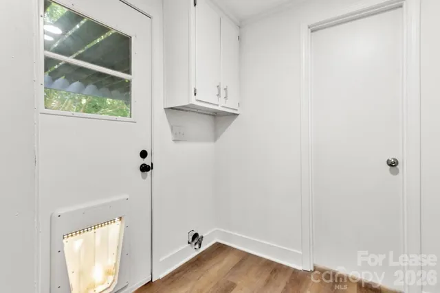 a view of small space with wooden floor and window