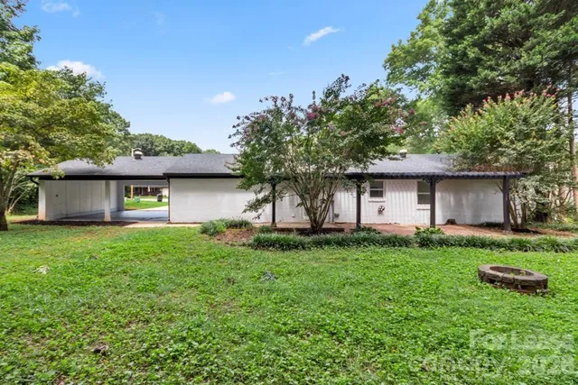 a front view of house with a garden